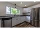 Modern kitchen featuring stainless appliances, granite countertops, and ample cabinets at 3256 S Ogden St, Englewood, CO 80113
