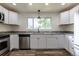 Bright kitchen with white cabinets, stainless appliances, granite countertops, and natural light at 3256 S Ogden St, Englewood, CO 80113