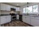 Bright kitchen with stainless appliances, granite countertops, and a window with a view at 3256 S Ogden St, Englewood, CO 80113