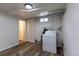 This Laundry room has a washer and drier with vinyl floors and white walls at 3256 S Ogden St, Englewood, CO 80113