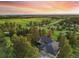 Panoramic aerial view of a home nestled among trees and green fields, with mountains visible in the distance at 121 County Road 146, Elizabeth, CO 80107