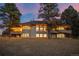 Rear exterior view of a house showcasing multiple windows, a balcony, and a partially covered patio at 121 County Road 146, Elizabeth, CO 80107