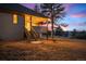 Backyard view with a covered patio, stairs to the yard, and fire pit at 121 County Road 146, Elizabeth, CO 80107