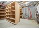 Unfinished basement with storage shelves and rough-in for future bathroom at 121 County Road 146, Elizabeth, CO 80107