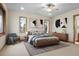 Bedroom with light-colored walls, and wood-framed windows that fill the room with light at 121 County Road 146, Elizabeth, CO 80107