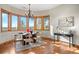 This dining room has wood floors, a modern chandelier, and a picturesque window view with plenty of natural light at 121 County Road 146, Elizabeth, CO 80107