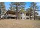 Back exterior elevation view of home, with wooden deck and lots of windows at 121 County Road 146, Elizabeth, CO 80107