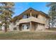 Beautifully landscaped exterior view of a multi-story home with stone accents and green grass at 121 County Road 146, Elizabeth, CO 80107