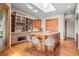 A kitchen with wood cabinets, stone countertops, a skylight, and bar seating offers space to entertain guests at 121 County Road 146, Elizabeth, CO 80107