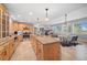 Open kitchen with island, natural cabinets, and a view to the living room at 121 County Road 146, Elizabeth, CO 80107