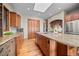 Spacious kitchen with custom wood cabinets, granite countertops, stainless steel appliances, and a large island at 121 County Road 146, Elizabeth, CO 80107