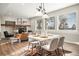 Sunlit dining area with table, chairs, and view, next to a living room with a fireplace at 121 County Road 146, Elizabeth, CO 80107