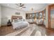 Spacious bedroom featuring a large bed, ceiling fan, and sitting area with beautiful bay windows at 121 County Road 146, Elizabeth, CO 80107