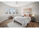 Bright bedroom with a large bay window, ceiling fan, and a plush white bedspread at 121 County Road 146, Elizabeth, CO 80107