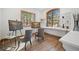Bright studio with two easel paintings, lots of natural light, and warm wood flooring at 121 County Road 146, Elizabeth, CO 80107