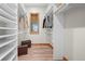 Walk-in closet with custom shelving and warm wood flooring at 121 County Road 146, Elizabeth, CO 80107
