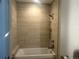 Elegant bathroom with a tiled shower-tub combo and modern fixtures creating a spa-like retreat at 4200 W 17Th Ave # 411, Denver, CO 80204