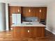 Modern kitchen with sleek wood cabinets, stainless steel appliances, and a large center island at 4200 W 17Th Ave # 411, Denver, CO 80204