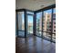 Bright living room showcasing hardwood floors, large windows and balcony offering stunning city and lake views at 4200 W 17Th Ave # 411, Denver, CO 80204