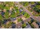 Neighborhood aerial view shows mature landscaping, street access, and nearby homes at 6114 Miller St, Arvada, CO 80004