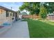 Spacious backyard features a concrete patio and lush green lawn, perfect for outdoor entertaining at 6114 Miller St, Arvada, CO 80004