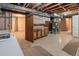 Basement with utility area, including washer, dryer, and exposed ceiling at 6114 Miller St, Arvada, CO 80004