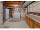 Basement utility area featuring a washer, dryer, refrigerator and countertop at 6114 Miller St, Arvada, CO 80004