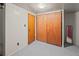 Basement bedroom with wall paneling, closet, carpeted flooring, and space for storage at 6114 Miller St, Arvada, CO 80004