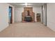 Basement featuring a wood-burning fireplace and wood storage niche in a carpeted area at 6114 Miller St, Arvada, CO 80004