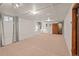 Spacious basement with carpet and drop ceiling, with neutral walls and warm lighting at 6114 Miller St, Arvada, CO 80004