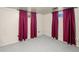 Finished basement room with gray carpet, red curtains, and natural light from the window at 6114 Miller St, Arvada, CO 80004