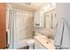 Bathroom featuring a shower-tub combo, a sink with a vanity and a mirrored medicine cabinet at 6114 Miller St, Arvada, CO 80004
