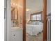 Bathroom view showcasing a vanity and a partial view into the main bedroom at 6114 Miller St, Arvada, CO 80004