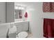 Basement bathroom with a toilet, vanity, and red themed decor to match the rest of the house at 6114 Miller St, Arvada, CO 80004