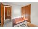 This bedroom features neutral walls, a dark wood closet, and a work desk for functionality at 6114 Miller St, Arvada, CO 80004
