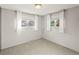 This bedroom features gray walls, carpet and two windows with views of the exterior at 6114 Miller St, Arvada, CO 80004