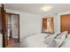 Bedroom showcasing an ensuite bathroom with a tiled shower and built in shelves at 6114 Miller St, Arvada, CO 80004