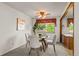 Cozy dining area with a round table, four chairs, and a stylish ceiling fan at 6114 Miller St, Arvada, CO 80004
