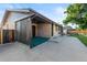 Back exterior with brick siding, back patio, and fenced in yard, as well as additional outdoor storage at 6114 Miller St, Arvada, CO 80004