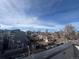 Rooftop view showcases neighborhood homes with tree-lined streets and a bright sky at 2330 Eliot St # 2, Denver, CO 80211