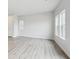 Bright, empty bedroom with large windows, neutral paint, and light wood floors at 19089 E 94Th Pl, Commerce City, CO 80022