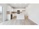 Bright, modern kitchen with white cabinets, an island, stainless steel appliances, and a minimalist design at 19089 E 94Th Pl, Commerce City, CO 80022