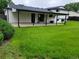 Spacious backyard featuring a large grassy lawn and covered patio, perfect for outdoor entertaining at 315 E 112Th Dr, Northglenn, CO 80233