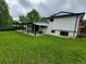 Expansive backyard view showcasing the lush lawn and covered patio area with updated home exterior at 315 E 112Th Dr, Northglenn, CO 80233