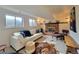 Cozy basement with a brick fireplace, plush seating, and natural light from the windows at 315 E 112Th Dr, Northglenn, CO 80233