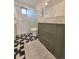 Modern bathroom showcasing stylish vanity, decorative tile floor, and updated shower with glass doors at 315 E 112Th Dr, Northglenn, CO 80233