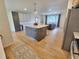 Bright open-concept kitchen featuring a large island, stainless appliances, and hardwood floors at 315 E 112Th Dr, Northglenn, CO 80233