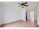 Spacious bedroom features light hardwood floors, white walls, a ceiling fan, and multiple doorways at 8197 S Fillmore Way, Centennial, CO 80122