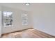 Sunny bedroom boasts two windows with neighborhood views and beautiful hardwood floors at 8197 S Fillmore Way, Centennial, CO 80122