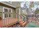 Exterior view of the deck with stained wood and wooden railing, steps to the backyard at 8197 S Fillmore Way, Centennial, CO 80122